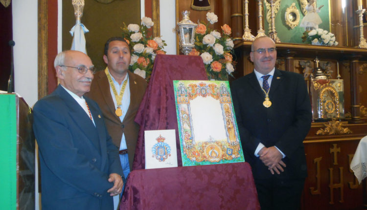 Hermandad de Emigrantes – Presenta su nueva orla de cultos y el escudo del cincuentenario